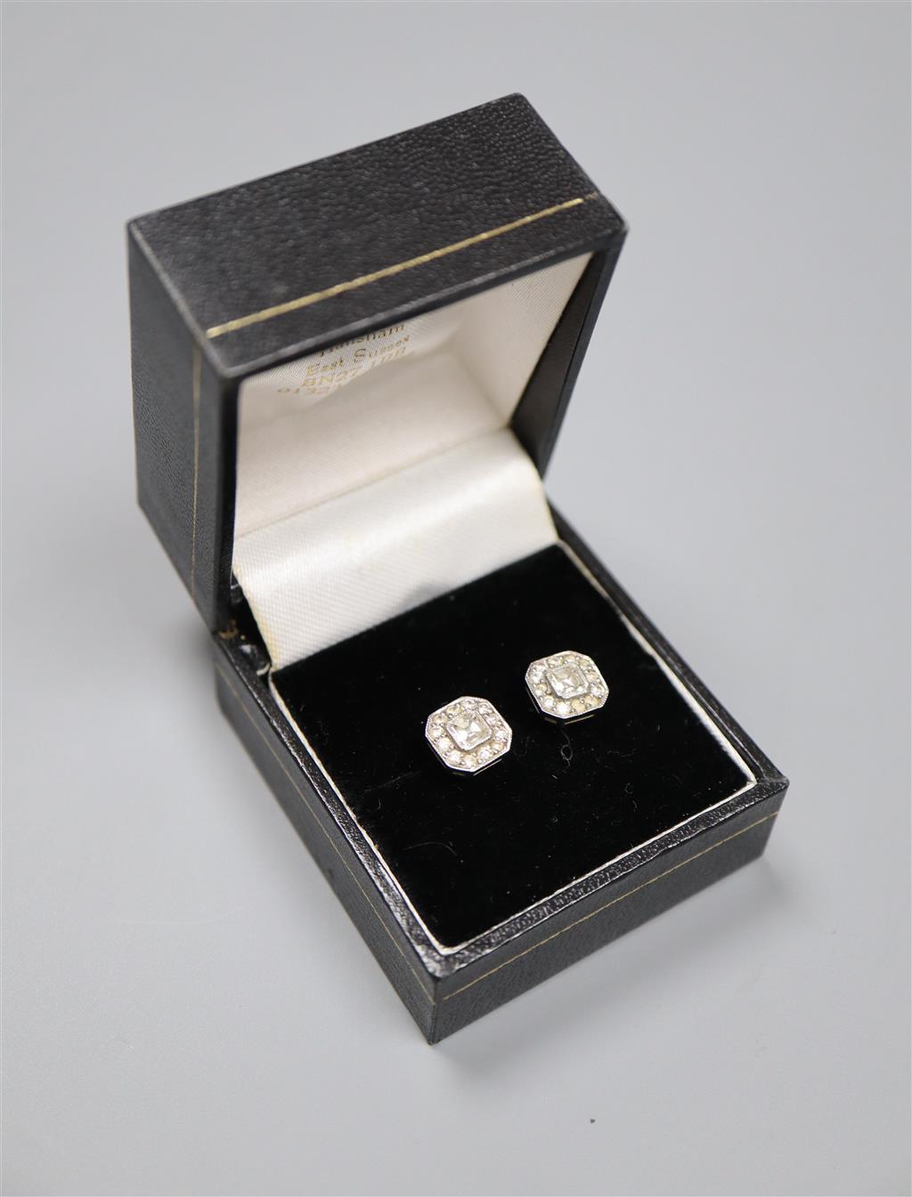 A pair of 750 white metal and octagonal diamond cluster ear studs, with asscher? cut central stones, 8mm, gross 2.7 grams.